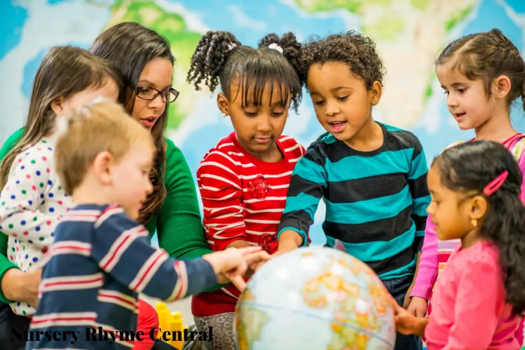 kids touching desk globe