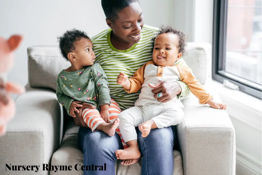 sitting woman carrying two babies on her lap